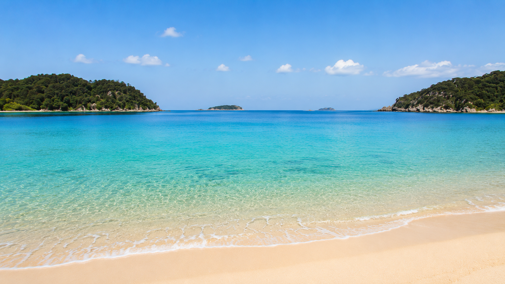 Clear turquoise water and golden sand at an Abel Tasman beach
