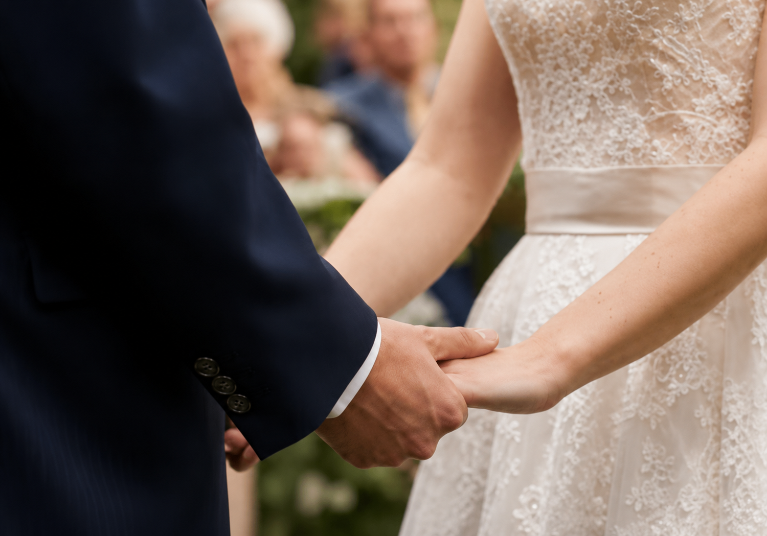 Bride and groom holding hands at their wedding ceremony